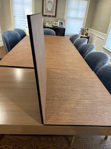 A dining table protected by a custom Suburban table pad.